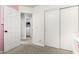 Hallway view to Laundry room with appliances and open closet with storage shelves at 14809 N El Frio Cir, El Mirage, AZ 85335