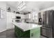 Modern kitchen with white cabinets, stainless steel appliances, and a spacious green island at 14809 N El Frio Cir, El Mirage, AZ 85335
