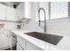Close-up of the kitchen sink and countertop, showcasing the stylish faucet and backsplash at 14809 N El Frio Cir, El Mirage, AZ 85335