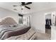 Inviting main bedroom with a tufted bench, walk-in closet, and neutral decor at 14809 N El Frio Cir, El Mirage, AZ 85335