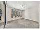 Bedroom features carpet floors, ceiling fan, and 3 windows with blinds and curtains at 15151 N Frank Lloyd Wright Blvd # 1088, Scottsdale, AZ 85260