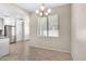 A dining area includes tile flooring, modern chandelier, and bright light from the window at 15151 N Frank Lloyd Wright Blvd # 1088, Scottsdale, AZ 85260