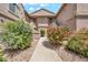 Charming condo exterior featuring colorful landscaping and well-maintained stucco facade at 15151 N Frank Lloyd Wright Blvd # 1088, Scottsdale, AZ 85260