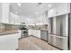 Bright kitchen features white cabinets, stainless steel appliances, and stylish backsplash at 15151 N Frank Lloyd Wright Blvd # 1088, Scottsdale, AZ 85260