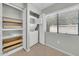 Bright laundry area with a stacked washer and dryer, shelving for storage, and a window at 15151 N Frank Lloyd Wright Blvd # 1088, Scottsdale, AZ 85260