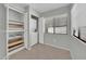 Bright laundry area with a stacked washer and dryer, shelving for storage, and a window at 15151 N Frank Lloyd Wright Blvd # 1088, Scottsdale, AZ 85260