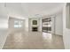 Bright, open living area with tile flooring, fireplace, and sliding glass door to balcony at 15151 N Frank Lloyd Wright Blvd # 1088, Scottsdale, AZ 85260