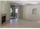 Living room featuring tile floors, fireplace, sliding glass doors to a balcony, and a ceiling fan at 15151 N Frank Lloyd Wright Blvd # 1088, Scottsdale, AZ 85260