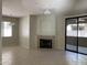 Spacious living room with a fireplace, tile flooring, ceiling fan and sliding glass doors to the outside at 15151 N Frank Lloyd Wright Blvd # 1088, Scottsdale, AZ 85260