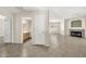 An open living room features tile flooring, fireplace, and access to bathroom and other rooms at 15151 N Frank Lloyd Wright Blvd # 1088, Scottsdale, AZ 85260