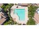 Aerial view of community pool and jacuzzi with patio furniture and desert landscaping at 15151 N Frank Lloyd Wright Blvd # 1088, Scottsdale, AZ 85260