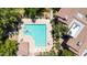 An aerial view of community pool featuring lounge seating, an umbrella shaded table and beautiful landscaping at 15151 N Frank Lloyd Wright Blvd # 1088, Scottsdale, AZ 85260