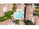 Aerial view of community pool featuring lounge seating, an umbrella shaded table and beautiful landscaping at 15151 N Frank Lloyd Wright Blvd # 1088, Scottsdale, AZ 85260