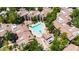 Aerial view of a community swimming pool with lounge chairs and mature trees that provide shade and beautiful landscaping at 15151 N Frank Lloyd Wright Blvd # 1088, Scottsdale, AZ 85260
