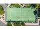Aerial view of a well-maintained tennis court surrounded by lush greenery in a gated community at 15151 N Frank Lloyd Wright Blvd # 1088, Scottsdale, AZ 85260