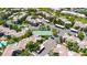 Aerial view of a well-maintained tennis court surrounded by lush landscaping and residential buildings, in a gated community at 15151 N Frank Lloyd Wright Blvd # 1088, Scottsdale, AZ 85260