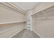 Spacious walk-in closet with multiple levels of shelving and rods for optimal storage organization at 15151 N Frank Lloyd Wright Blvd # 1088, Scottsdale, AZ 85260