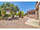 Lush backyard featuring desert landscaping, mature trees, and a serene outdoor space at 15161 W Cactus Ridge Way, Surprise, AZ 85374
