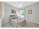 Bedroom with a window, neutral carpet, and decorative wall art at 15161 W Cactus Ridge Way, Surprise, AZ 85374