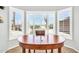 Cozy dining area featuring a bay window with plantation shutters and wood table at 15161 W Cactus Ridge Way, Surprise, AZ 85374
