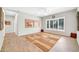 Open living room with light wood flooring, and soft grey walls, ideal for relaxing and entertaining at 15161 W Cactus Ridge Way, Surprise, AZ 85374