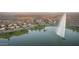 Breathtaking aerial view of a lakeside neighborhood with a water fountain and mountain views at 16276 E Rosetta Dr # 58, Fountain Hills, AZ 85268