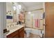 Cozy bathroom with glass-doored tub, wooden cabinets, and a well-lit mirror and vanity at 16276 E Rosetta Dr # 58, Fountain Hills, AZ 85268