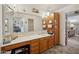 Bathroom featuring wood cabinets, laminate counters, and an adjacent doorway at 16276 E Rosetta Dr # 58, Fountain Hills, AZ 85268
