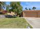 Attractive front yard featuring desert landscaping, a green lawn, and a beige home exterior at 16276 E Rosetta Dr # 58, Fountain Hills, AZ 85268