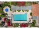 Overhead view of a community pool with lounge chairs and colorful flowers at 16734 E Gunsight Dr # 109, Fountain Hills, AZ 85268