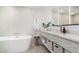 Modern bathroom with soaking tub, marble countertop, and herringbone patterned tile at 16734 E Gunsight Dr # 109, Fountain Hills, AZ 85268
