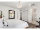 Bedroom with modern light fixture, wood floors, and en suite bathroom with marble tile at 16734 E Gunsight Dr # 109, Fountain Hills, AZ 85268