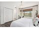 Bedroom with a view from the window, modern light fixture, and wood floors at 16734 E Gunsight Dr # 109, Fountain Hills, AZ 85268