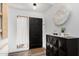 Well-lit entryway with a black door, decorative elements, and modern accents creating a welcoming ambiance at 16734 E Gunsight Dr # 109, Fountain Hills, AZ 85268