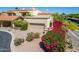 Inviting exterior with tile roof, desert landscaping, and a tan garage door on a sunny day at 16734 E Gunsight Dr # 109, Fountain Hills, AZ 85268