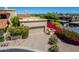 Home exterior featuring a two-car garage, mature landscaping, and desert flora at 16734 E Gunsight Dr # 109, Fountain Hills, AZ 85268