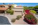 Charming home featuring a private garage, gravel driveway, and vibrant flowering shrubbery at 16734 E Gunsight Dr # 109, Fountain Hills, AZ 85268
