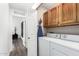 Convenient laundry room with washer, dryer, cabinets and view into den with console at 16734 E Gunsight Dr # 109, Fountain Hills, AZ 85268