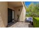Cozy patio featuring stylish outdoor furniture, desert plants, and a security door entrance at 16734 E Gunsight Dr # 109, Fountain Hills, AZ 85268