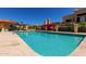Community pool with lounge chairs and colorful flowers at 16734 E Gunsight Dr # 109, Fountain Hills, AZ 85268