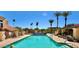 Inviting community pool with surrounding palm trees and greenery at 16734 E Gunsight Dr # 109, Fountain Hills, AZ 85268