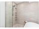 Shower with built in shelves and marble tile adjacent to a soaking tub at 16734 E Gunsight Dr # 109, Fountain Hills, AZ 85268