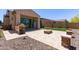 Outdoor entertainment space featuring an outdoor kitchen, seating area, and desert landscaping at 1824 N Red Clf, Mesa, AZ 85207