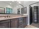 Bathroom featuring a double vanity with dark wood cabinets and a large framed mirror at 1824 N Red Clf, Mesa, AZ 85207