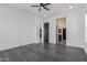 Bedroom featuring a ceiling fan, gray tile floors, many windows, and views into the kitchen and bathroom at 1824 N Red Clf, Mesa, AZ 85207