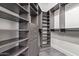 Walk-in closet with custom shelving, drawers, and lots of storage space at 1824 N Red Clf, Mesa, AZ 85207