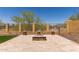 Backyard scene of fire pit area with tiled patio, stone seating and metal fence at 1824 N Red Clf, Mesa, AZ 85207