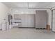 Spacious garage equipped with storage cabinets and a water softener, designed for organization and functionality at 1824 N Red Clf, Mesa, AZ 85207