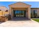 Outdoor kitchen area with a stone-clad grill and large sliding glass doors leading to the indoors at 1824 N Red Clf, Mesa, AZ 85207