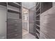 Custom walk-in closet with built-in shelving and drawers, providing ample storage and organization at 1824 N Red Clf, Mesa, AZ 85207